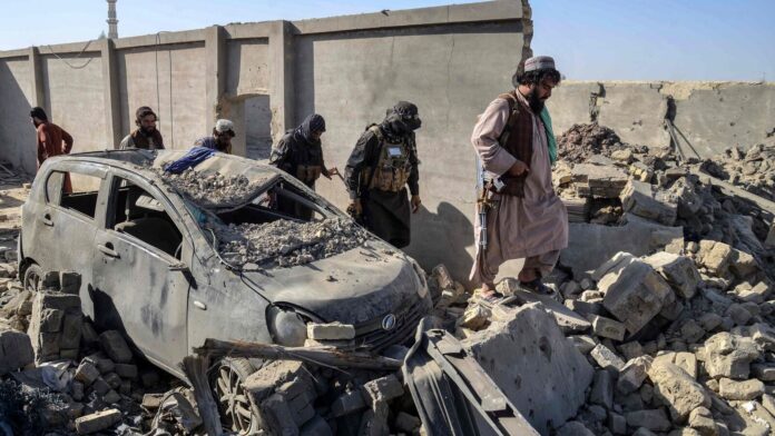 Afghanistan claims ‘truce broken’, vows to retaliate as fresh Pakistani Taliban security personnel walk past a damaged car in the Spin Boldak district of Kandahar province on October 16