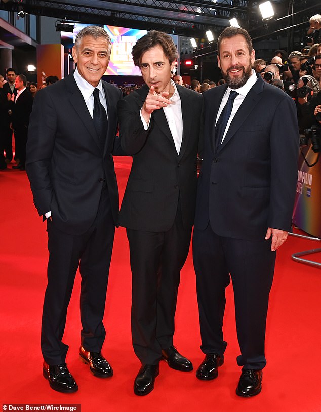 George plays movie star Jay Kelly in the upcoming Netflix film opposite Adam Sandler, who portrays Kelly's dedicated manager Ron (pictured with the film's director Noah Baumbach)