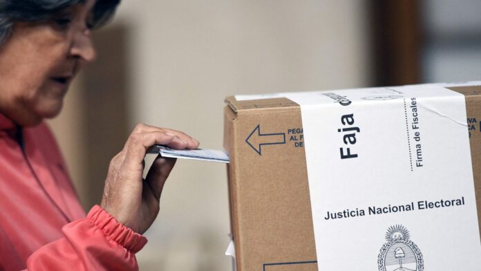 Argentinian elections will test populist President Javier Milei's policies—What's at A woman casts her vote at a polling station during the national midterm legislative election in La Plata, Buenos Aires Province, Argentina, on October 26, 2025. Argentines head to the polls for a midterm election that will determine whether President Javier Milei enters the second half of his term bolstered or diminished as economic troubles abound despite unprecedented US aid.