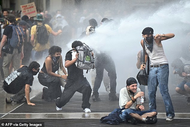 Riot police forces use a water cannon to disperse protesters during a demonstration part of the 'Let's Block Everything' protest movement, at the Place de la Comedie, in Montpellier, southern France, on September 10, 2025