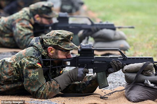 German police 'engage in gun battle with soldiers - with File photo: Volunteer reservist soldiers shoot Heckler & Koch G36 rifles as they train near the Clausewitz-Kaserne barracks on October 23, 2024 in Nienburg, Germany