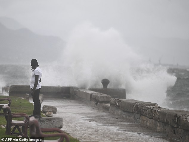 Jamaica to be hit by 'worst ever hurricane': Hundreds of A man watches the waves crash into the walls at the Kingston Waterfront on October 27, 2025