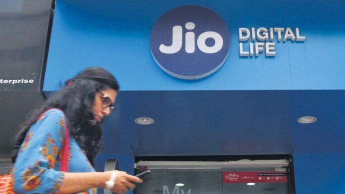 Jio down? Hundreds of users complain about network connectivity issues FILE PHOTO: A woman checks her mobile phone as she walks past a mobile store of Reliance Industries' Jio telecoms unit, in Mumbai, India, July 11, 2017. REUTERS/Shailesh Andrade/File Photo (REUTERS)