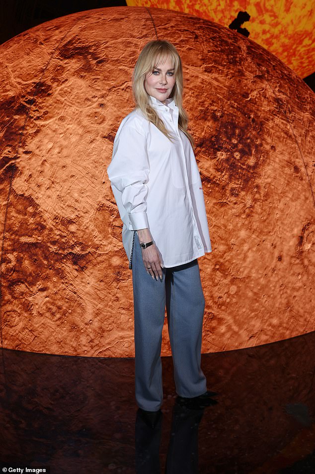 Despite the heartbreak she looked gorgeous for the Chanel show, wearing an oversized white shirt and blue trousers