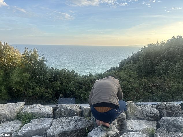 The UK's 'most dangerous' migrant town: Resort where hotel migrants 'Take me home': Jordanian asylum seeker Ahmad Hani (pictured overlooking the sea view) does not feel safe in Bournemouth and wants to return home