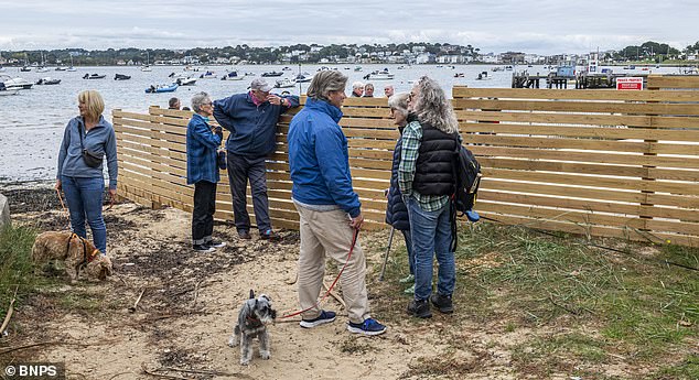 Sandbanks residents have been shut off from the beach after an ¿oppressive¿ timber fence was erected at the edge of Mr and Mrs Penfold¿s property