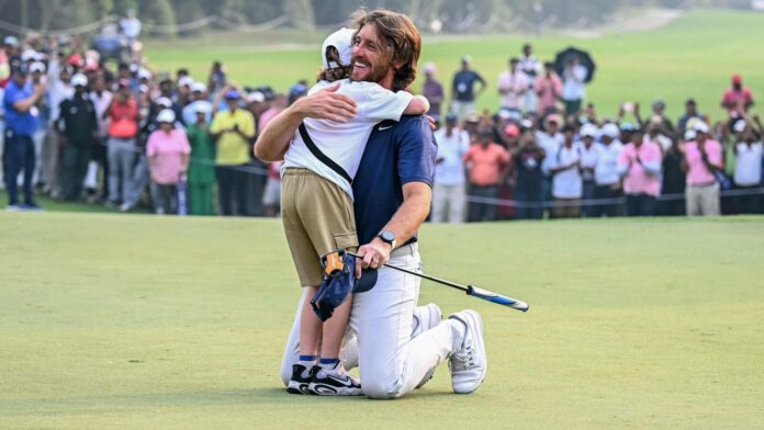 Tommy Fleetwood wins 2025 DP World India Championship, celebrates with Tommy Fleetwood (R) celebrates with his son after winning the DP World India Championship 2025 golf tournament at the Delhi Golf Club in New Delhi.