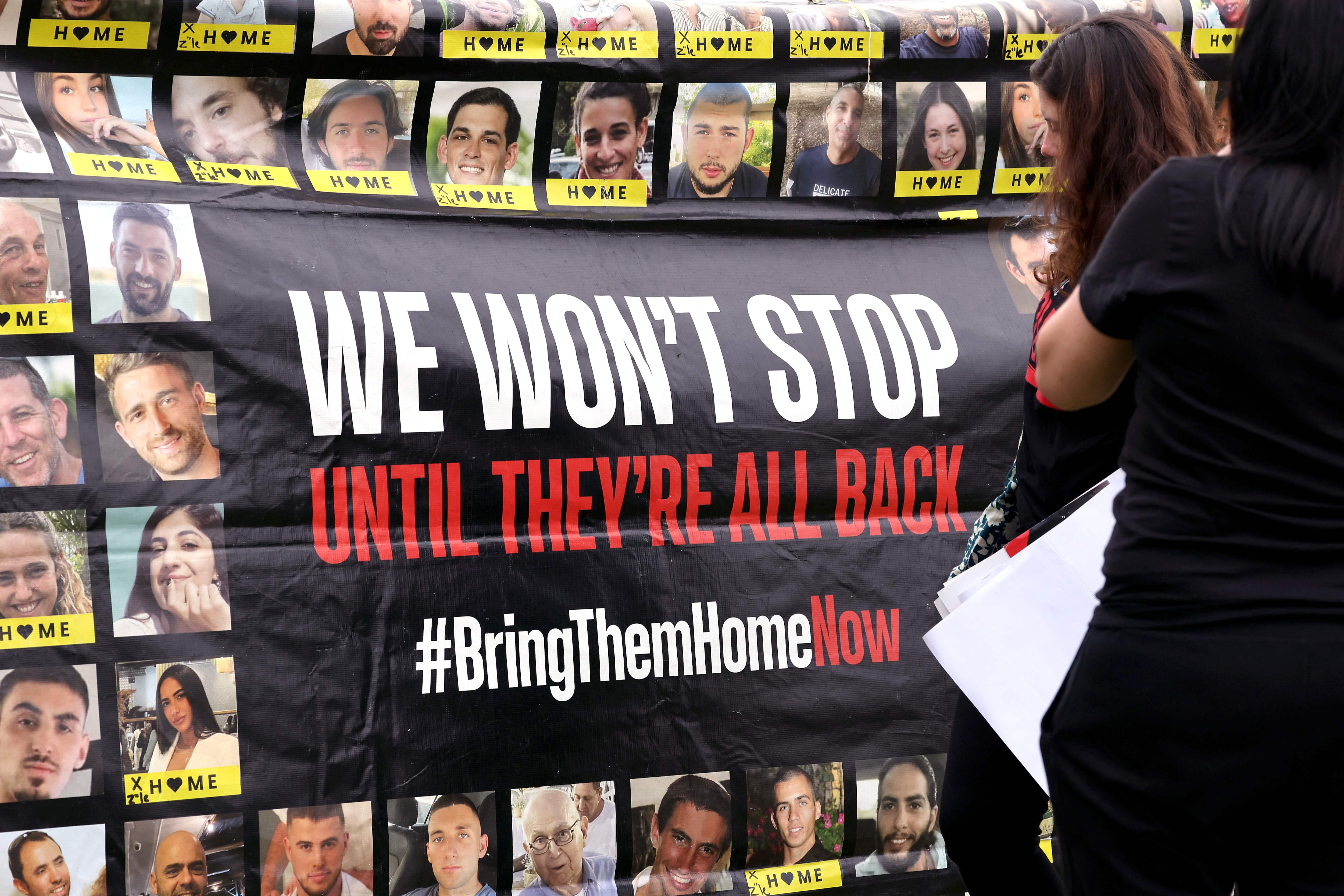Members of the Australian Jewish community hold a banner bearing the portraits of Israelis held hostage in the Gaza during a rally in Sydney(AFP) Members of the Australian Jewish community hold a banner bearing the portraits of Israelis held hostage in the Gaza during a rally in Sydney(AFP)