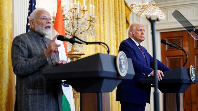 ‘56-inch chest is quiet’: Congress jabs at PM Modi after FILE PHOTO: US President Donald Trump listens as Indian Prime Minister Narendra Modi speaks during a joint press conference at the White House in Washington in February 2025.
