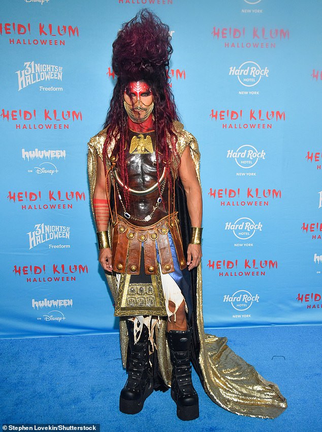 Former America's Next Top Model host Jay Manuel dressed in an elaborate costume, including a pair of chunky black boots