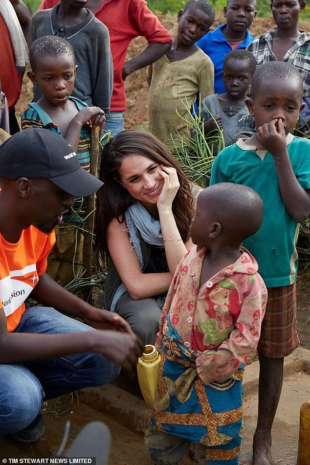 Meghan, before she was Duchess of Sussex, pictured in Rwanda. Tom Bower claimed she 'disappeared with [photographer] Gabor Jurina' for hours to take pictures that were later published on his website