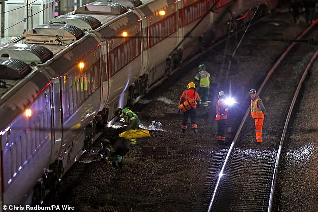 Emergency responders on the tracks by the train at Huntingdon station in Cambridgeshire