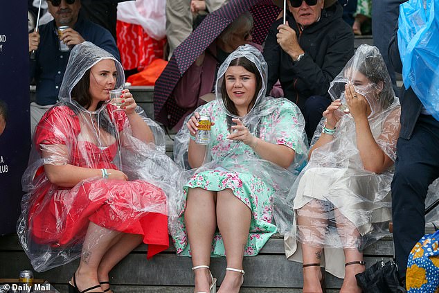 Attendees fought to stay dry in the wet weather