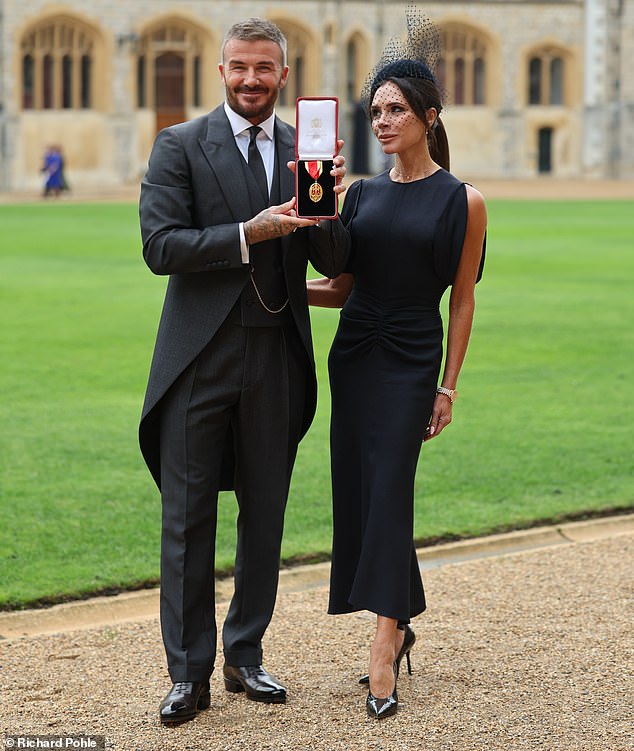 With a hand pressed against her husband's back, Victoria struggled to contain her emotions