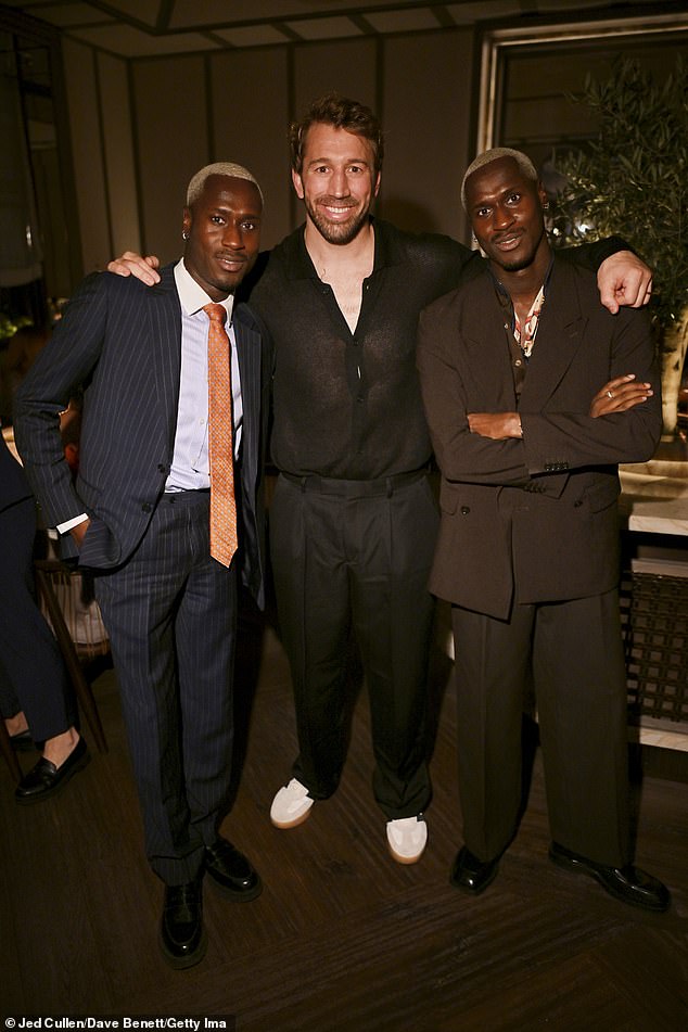 Chris posed with Kevin Bonsu and Karlon Bonsu, aka The Flag Twins who are known for their work as models, DJs, and creative consultants