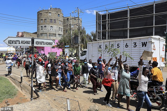 Kenyan sex workers hold placards and shout slogans in the streets during a protest in October 2021 against the murder and harassment of their colleagues in recent years by their clients - who they claim the majority of which are British soldiers