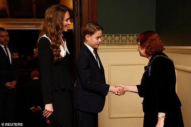 A future King in training! George shakes hands as he makes his debut at the Remembrance Festival