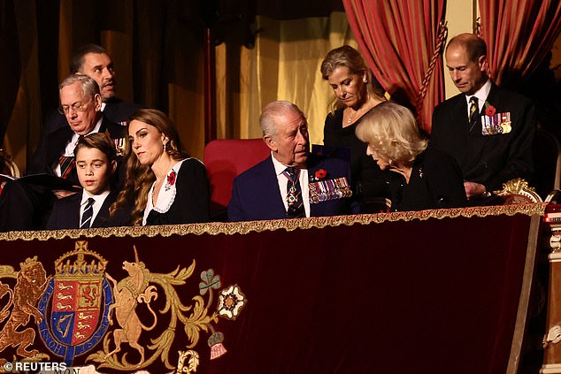 Prince George speaks to his mother as he enjoys the show alongside other senior royals