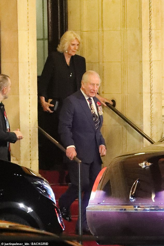 King Charles and Queen Camilla head towards a blacked out car as they leave the event