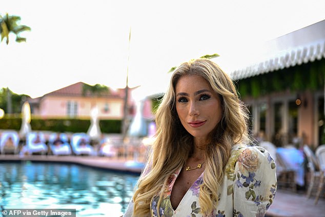 Melissa Rein Lively, 40, poses at a hotel in Palm Beach, Florida, for a recent feature about women who wear support for the US president on their face, known as the 'MAGA look'