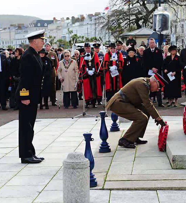 The suspected imposter then marched off to take his place next to the VIPs including the mayor, after saluting during the event honouring Britain's fallen heroes
