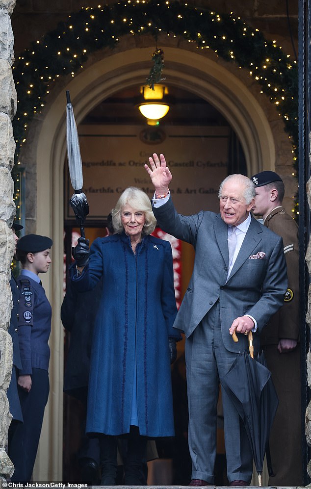 The King and Queen wave as they depart from a visit to Cyfarthfa Castle on Friday