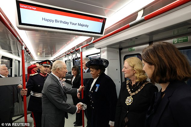 Charles meets dignitaries as he travels on a Stadler Class 398 Tram during a visit to officially open the South Wales Metro Depot