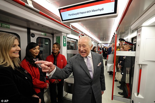 Later the King (pictured on the tram) received another 'money-can't-buy' gift - getting the chance to drive a tram-train as he officially opened a £100 million depot in Wales