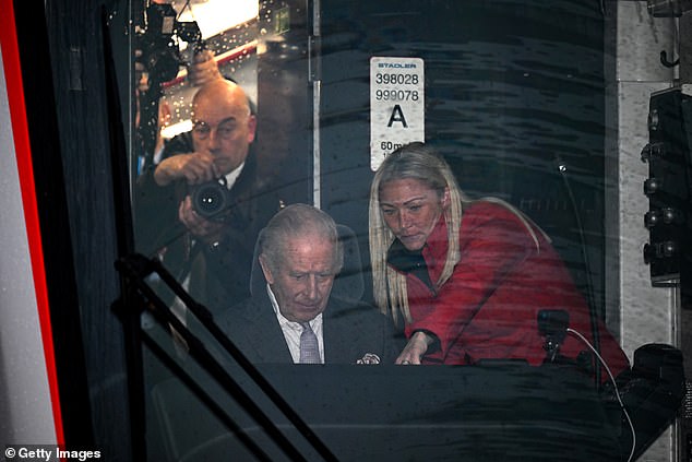 Charles takes the controls of a tram-train officially named Myddfai within the depot