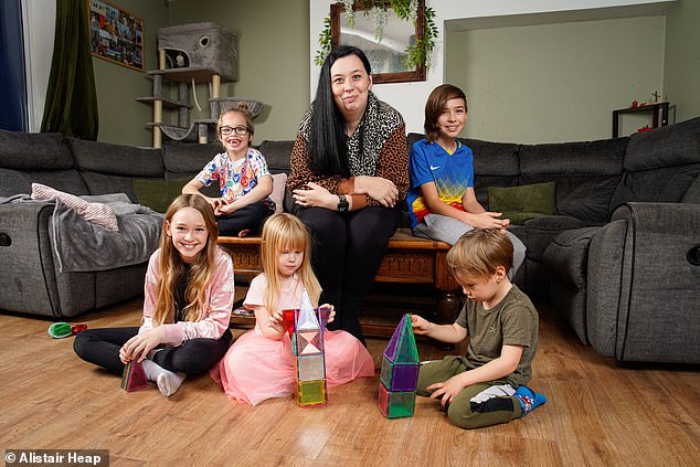 Ms White and her children. The family's domestic budget comes entirely from the public purse ¿ and they are among almost 200,000 large families set to receive thousands of pounds more in state handouts amid the widely anticipated removal of the two-child benefits cap