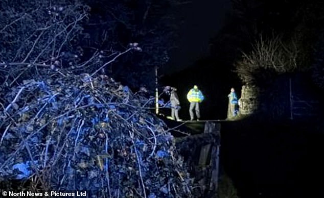 In another photo, investigators in high-vis jackets can be seen scouring the river at night