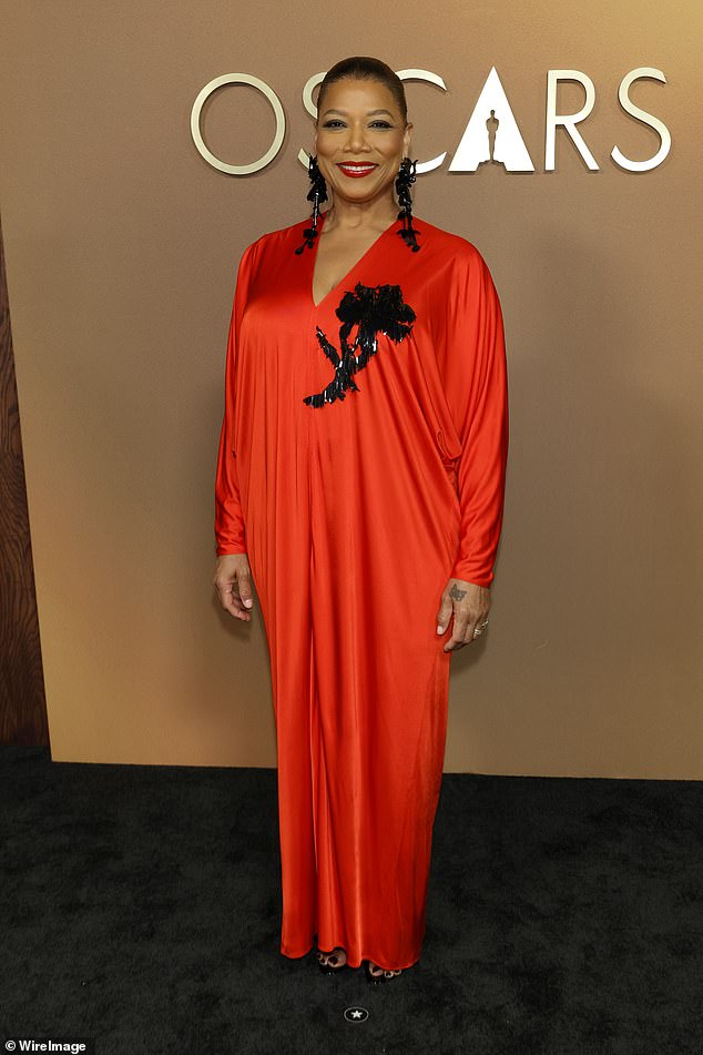 Queen Latifah sported an unflattering bright red number featuring an unusual shiny fringed design at the chest