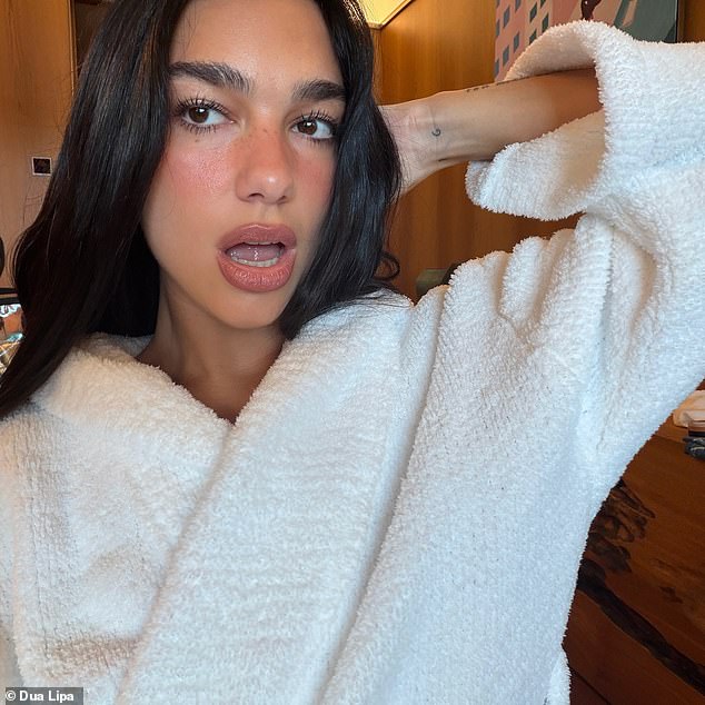 The pop star also posed in a white fluffy robe and rocked a full face of makeup