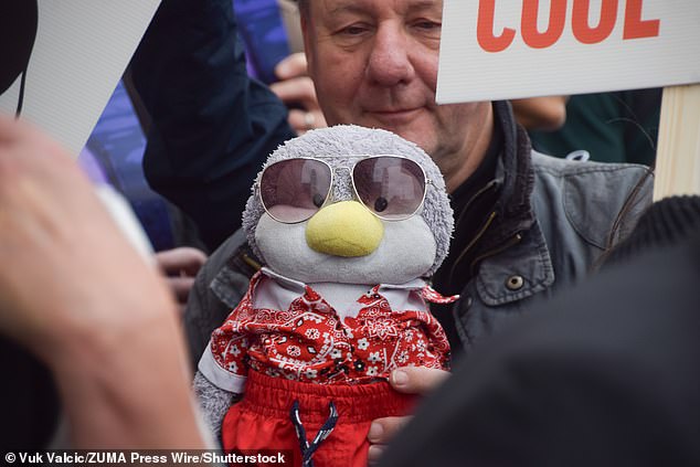 Protesters gather outside Sea Life demanding that the aquarium frees the penguins amid a growing campaign over concerns for the animals' welfare