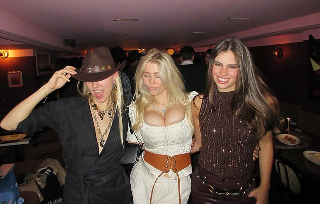 Claudia Schiffer's daughter Clementine, 21, enjoys a cowboy-themed party in a Wild West-style corset and leather belt