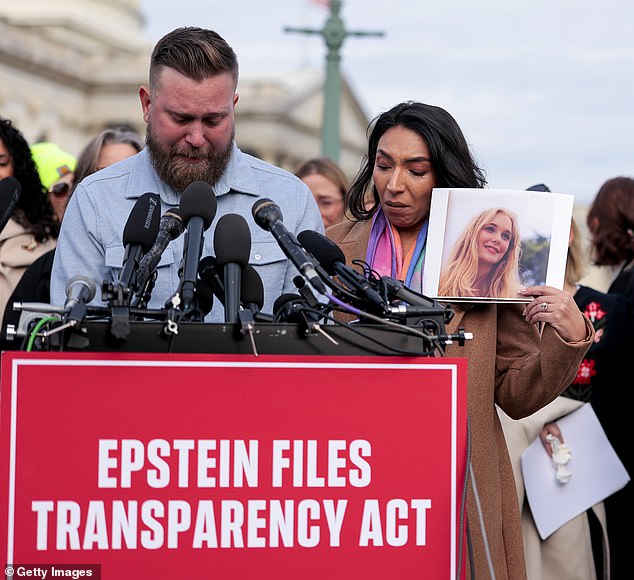 WASHINGTON, DC - NOVEMBER 18: Sky Roberts (L), brother of Virginia Giuffre, who was abused by Jeffrey Epstein, and his wife Amanda Roberts hold up a photo of Giuffre as they speak during a news conference with lawmakers on the Epstein Files Transparency Act outside the U.S. Capitol on November 18, 2025 in Washington, DC. Virginia Giuffre died by suicide in April 2025. The House is expected to vote today on the legislation, which instructs the U.S. Department of Justice to release all files related to the late accused sex trafficker Jeffrey Epstein. (Photo by Heather Diehl/Getty Images)
