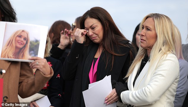 WASHINGTON, DC - NOVEMBER 18: Epstein abuse survivor Haley Robson (C) reacts alongside Rep. Marjorie Taylor Greene (R-GA) (R) as the family of Virginia Giuffre speaks during a news conference with lawmakers on the Epstein Files Transparency Act outside the U.S. Capitol on November 18, 2025 in Washington, DC. The House is expected to vote today on the legislation, which instructs the U.S. Department of Justice to release all files related to the late accused sex trafficker Jeffrey Epstein. (Photo by Heather Diehl/Getty Images)