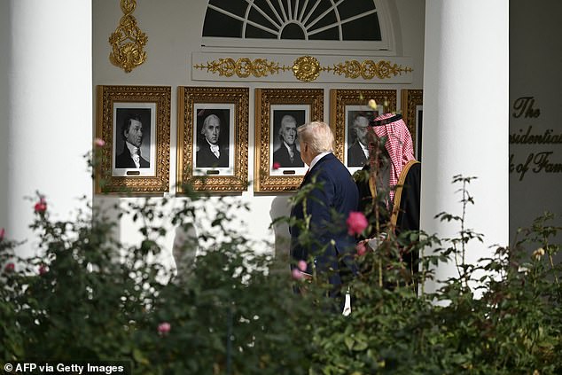 Trump and Crown Prince and Prince Mohammed bin Salman walk down the Colonnade on the way to the Oval Office of the White House in Washington, DC on November 18