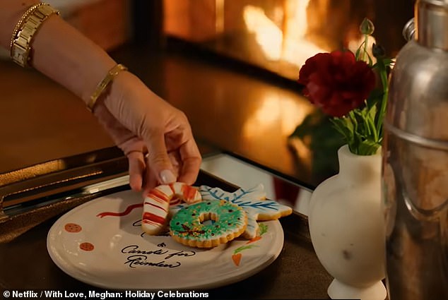 Noting how the gift-giving time of year is all about 'embracing tradition', Meghan can be seen organising a plate of Christmas-themed cookies and a cup of milk