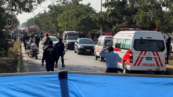 At least 5 killed in car bomb explosion outside Islamabad Police officers and ambulances on the road, that is cordoned off, after a blast outside a court building in Islamabad, Pakistan November 11, 2025
