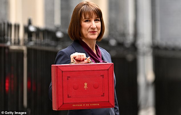 LONDON, ENGLAND - OCTOBER 30: Chancellor of the Exchequer, Rachel Reeves, poses with the red Budget BoxÂ as she leaves 11 Downing Street to present the government's annual budget to Parliament on October 30, 2024 in London, England. This is the first Budget presented by the new Labour government and Chancellor of the Exchequer, Rachel Reeves. (Photo by Leon Neal/Getty Images)